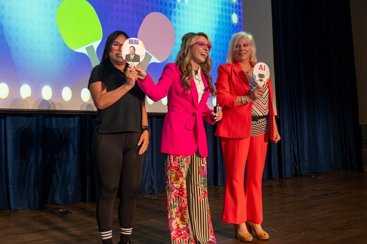 AI speaker Katie Linendoll playing the Real or AI game with audience volunteers on stage